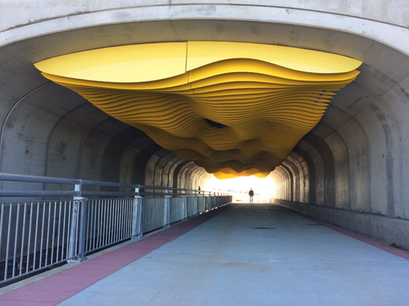 This 23' x 128' installation is an inverted sculpture of sand dune forms. It is installed in a pedestrian underpass tunnel under Central Park Boulevard between 53rd and 54th in Denver, Colorado