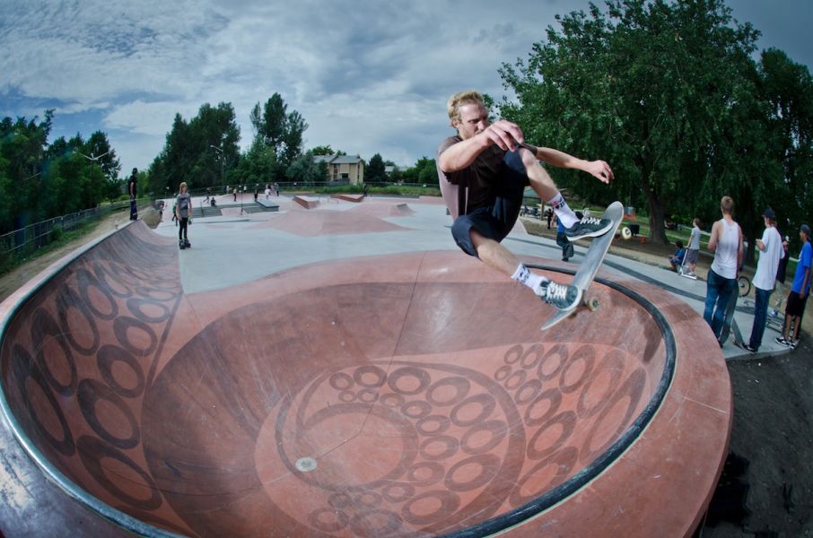 Skateboarder catching air over the coping of the Tentabowl